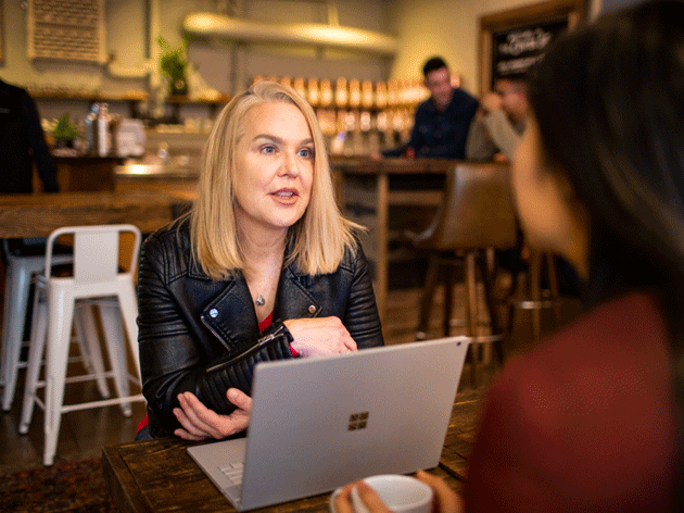 Woman speaking in front of laptop