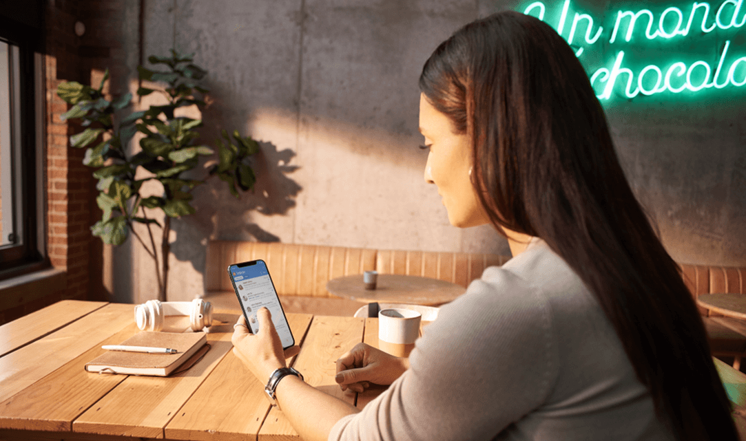 A woman using an Outlook add-in on her iPhone