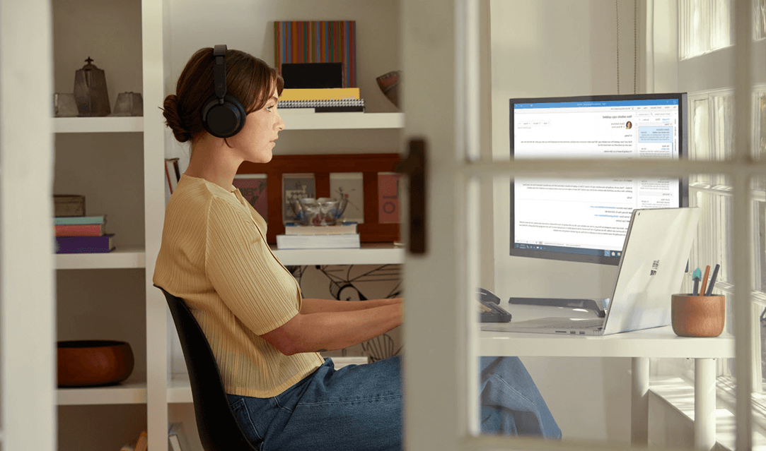 A woman using Outlook while working from home